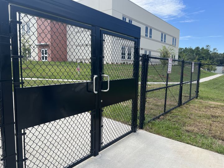 Black chain-link access gates at a commercial facility.