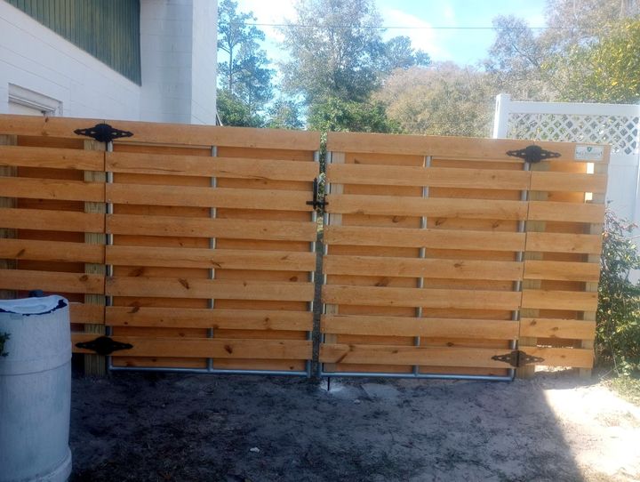 Custom horizontal wood double swing gate with black hardware.
