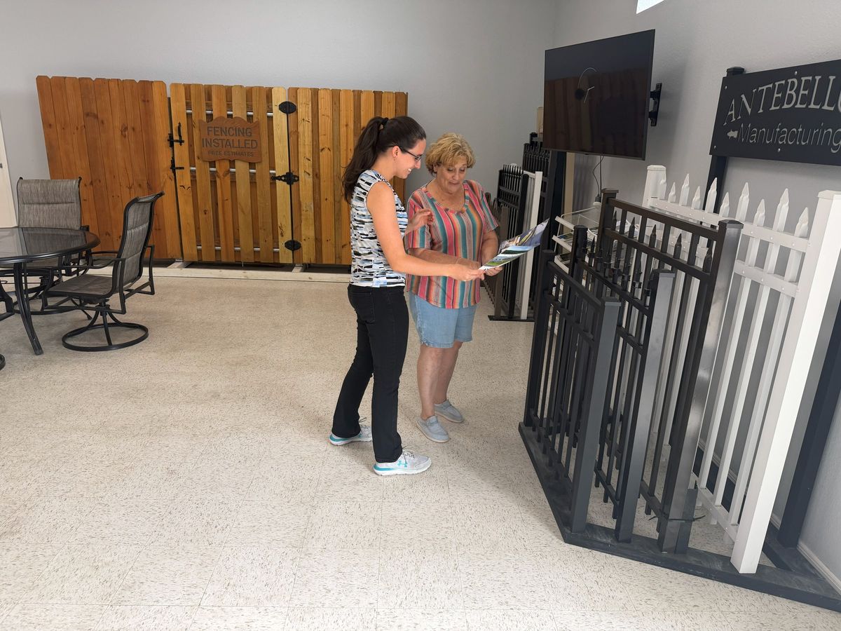 Customers reviewing fence options with a team member at the All Florida Design Center in Newberry, Florida.